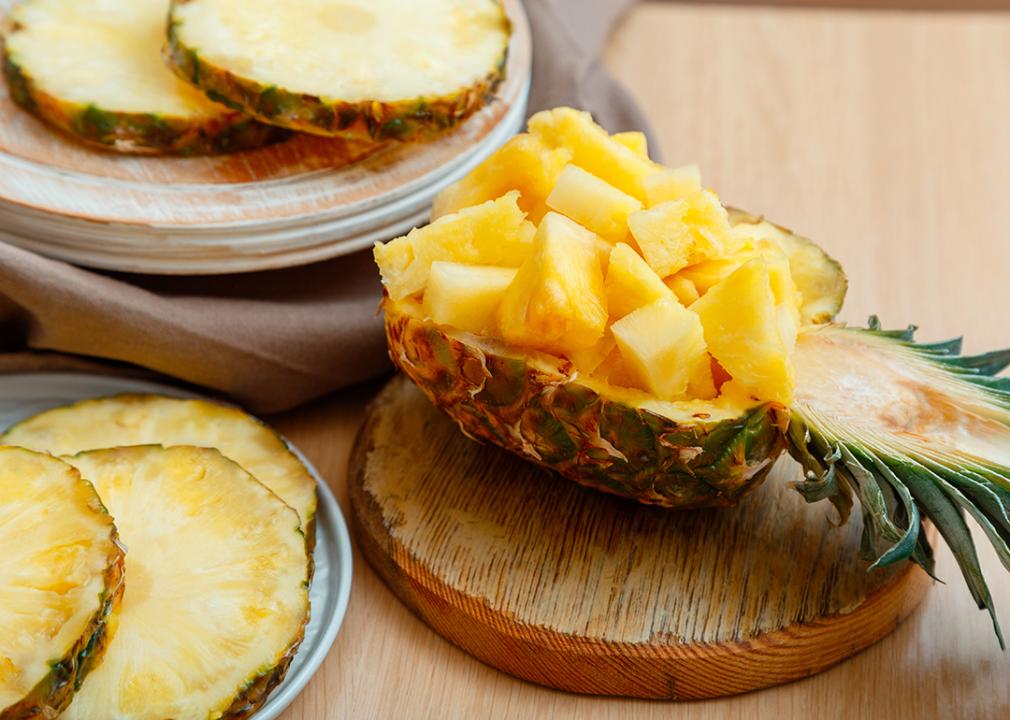 Fresh pineapple slices plated in a half pineapple.