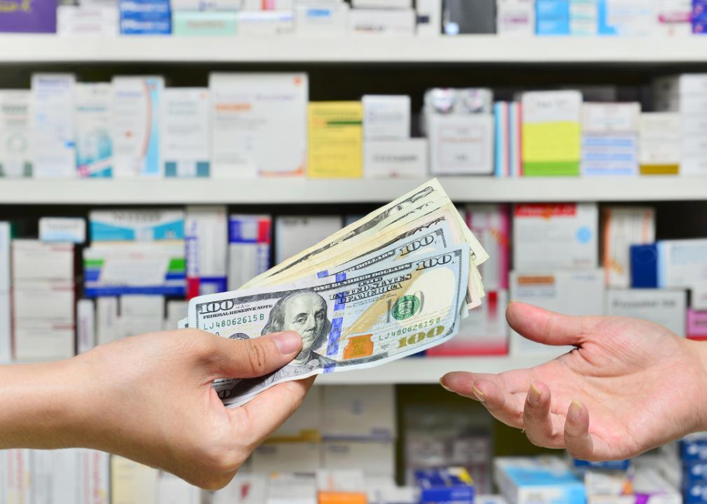 A customer purchasing at the pharmacy with cash.