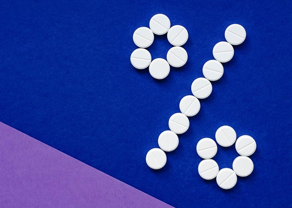 Discount on prescription drugs depicted by medicine tables forming a percentage sign.