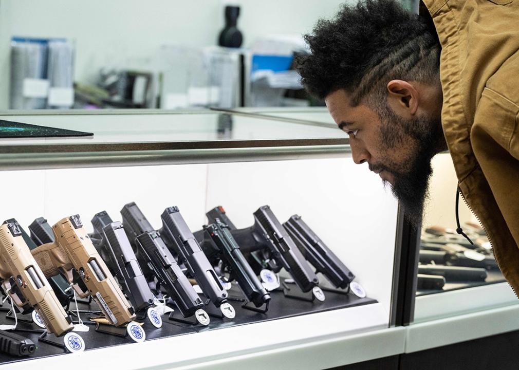 Jordan Landis, a gun collector, looks at guns in EJB