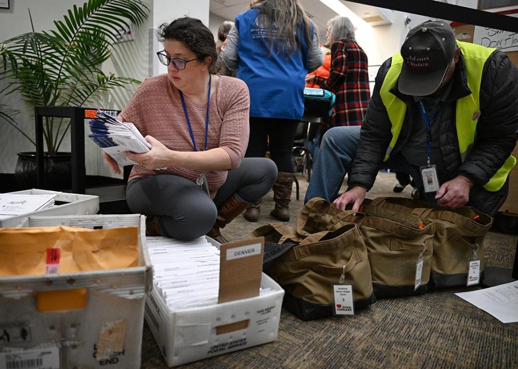  Denver Elections personnel administrator Elizabeth Littlepage, left, and election worker William Goad, sort through ballots that need to go to specific counties at the Denver Elections Division.