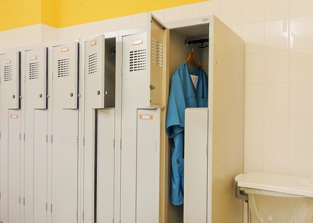 Only one of a row of metal lockers for nurses is occupied in a hospital illustrating staff shortage.