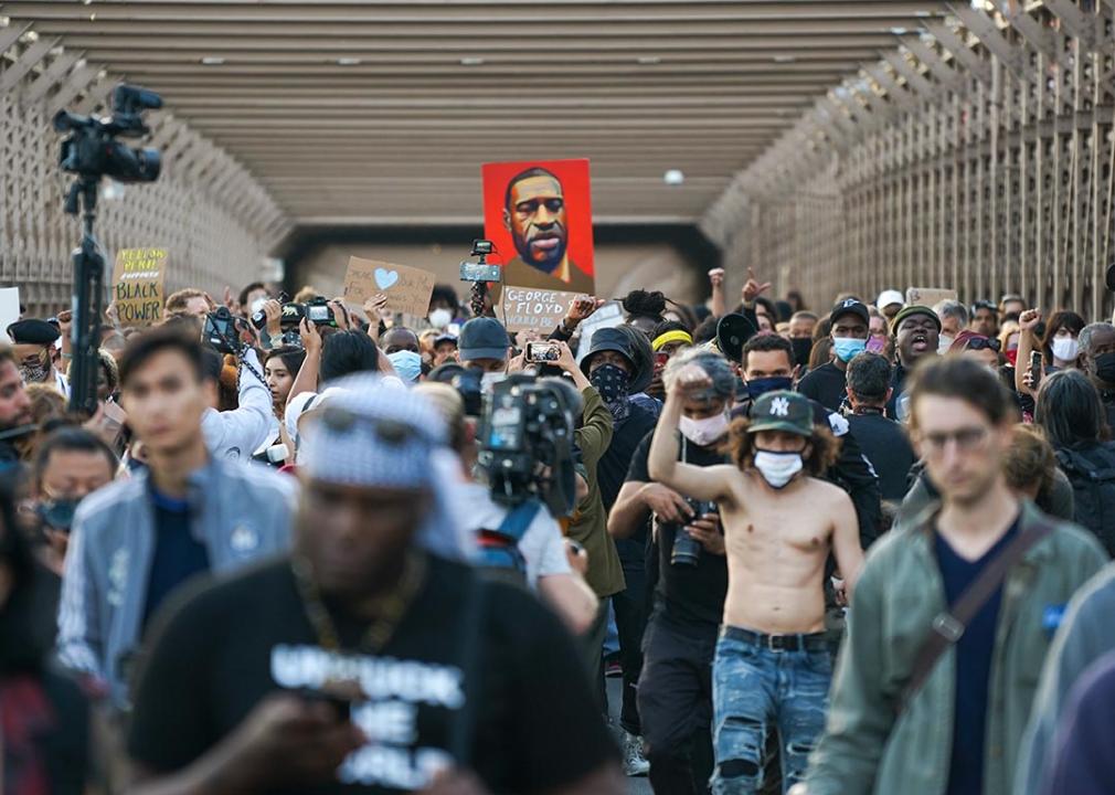 Marchers cross the Brooklyn Bridge demanding police reform after a commemoration to honor the anniversary of George Floyd