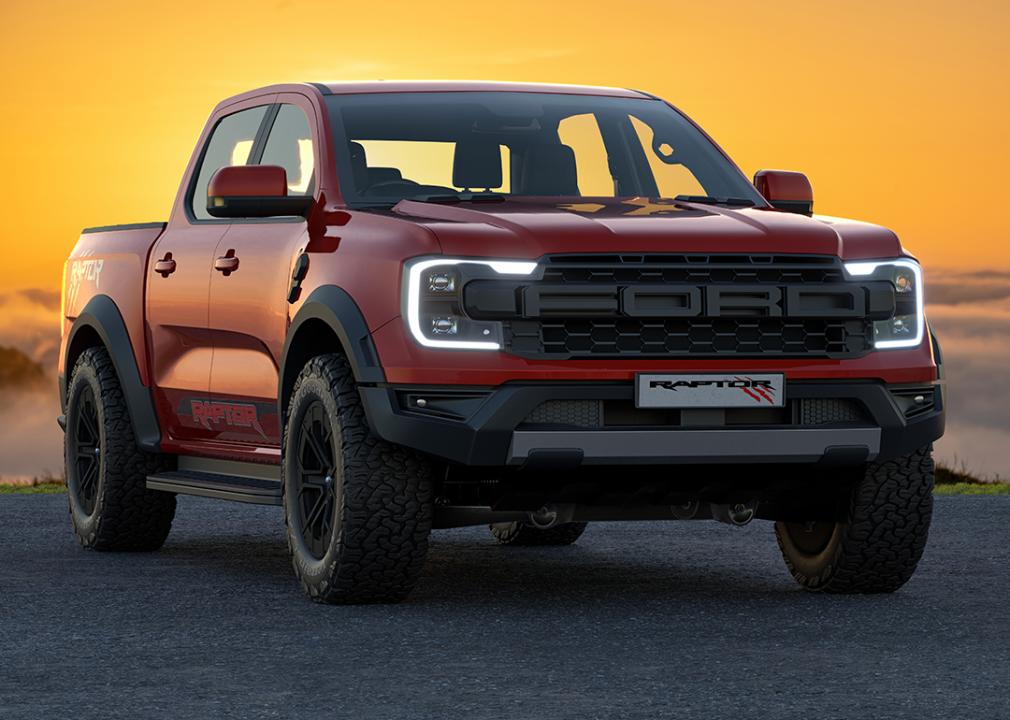 A red 2023 Ford Ranger Raptor with the sun setting in the background.