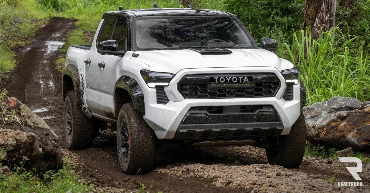 A white Toyota Tacoma TRD Pro on a muddy road.