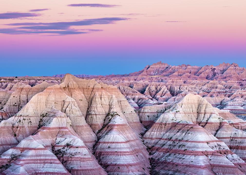 A view of the rock formations in Badlands National Park in South Dakota during sunset.