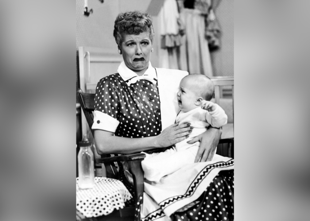 Lucille Ball with an overwhelmed, crying face holds a crying infant in the 1953 I Love Lucy episode No Children Allowed. 