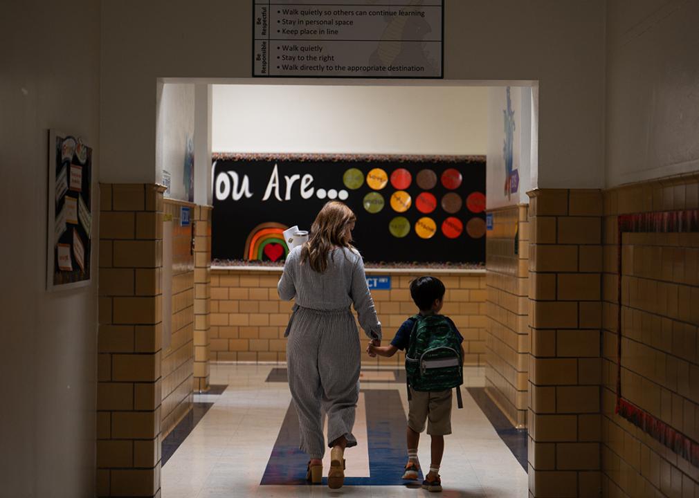 An English language teacher leads a student to their classroom at George Mason Elementary School in Alexandria, Virginia.