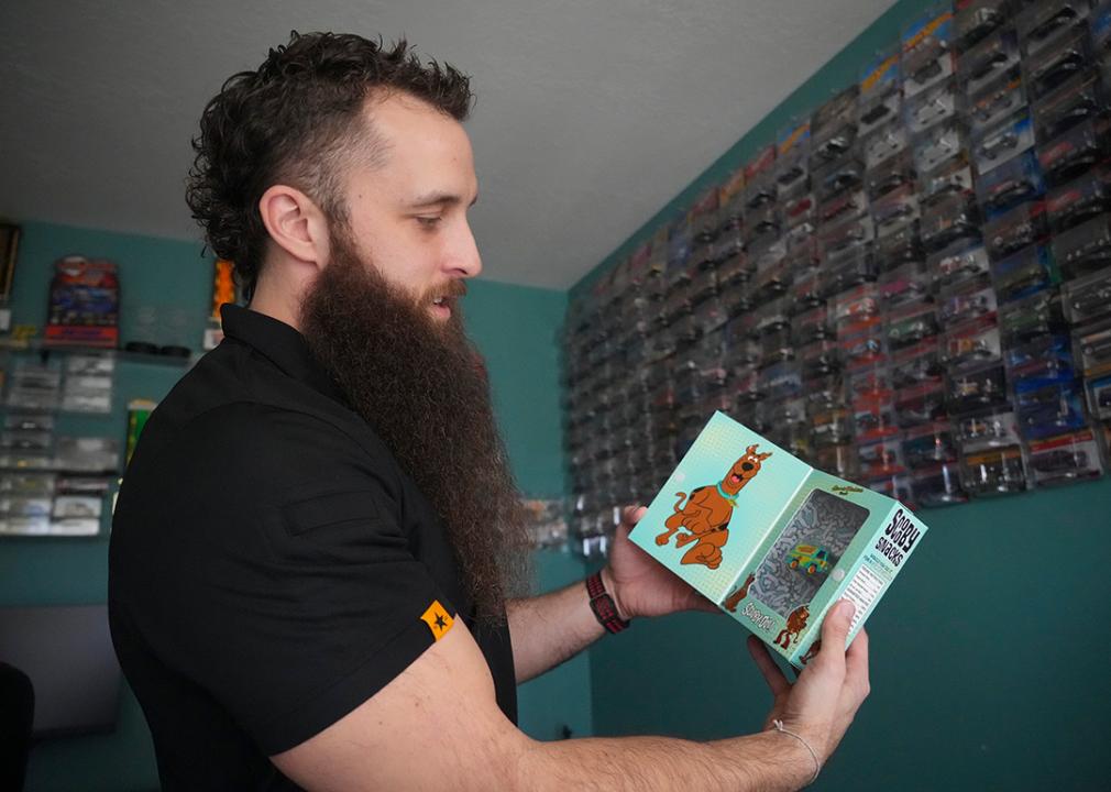 Ian Weber holding a scooby doo van from his Hot Wheel collection.