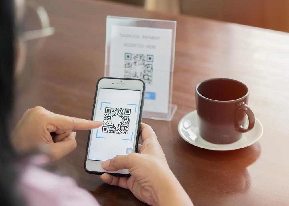 A customer scans a cafe's QR code for payment.