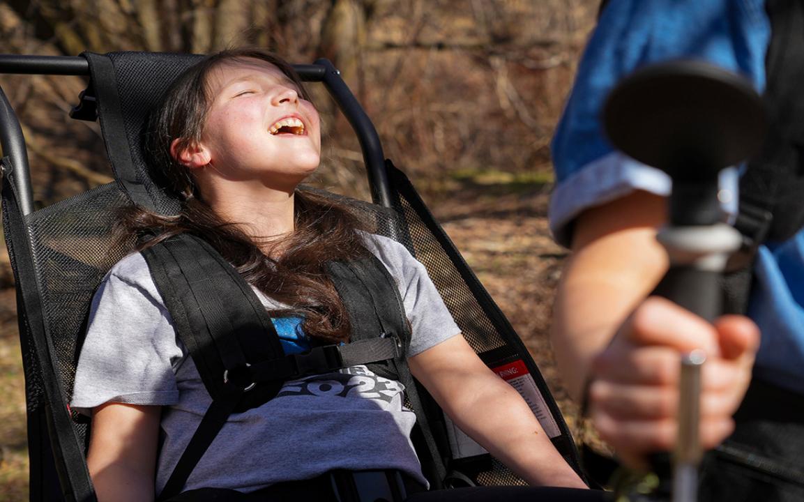 Luci Wilde reacts as she rides in a hiking cart designed by her dad, LJ Wilde.