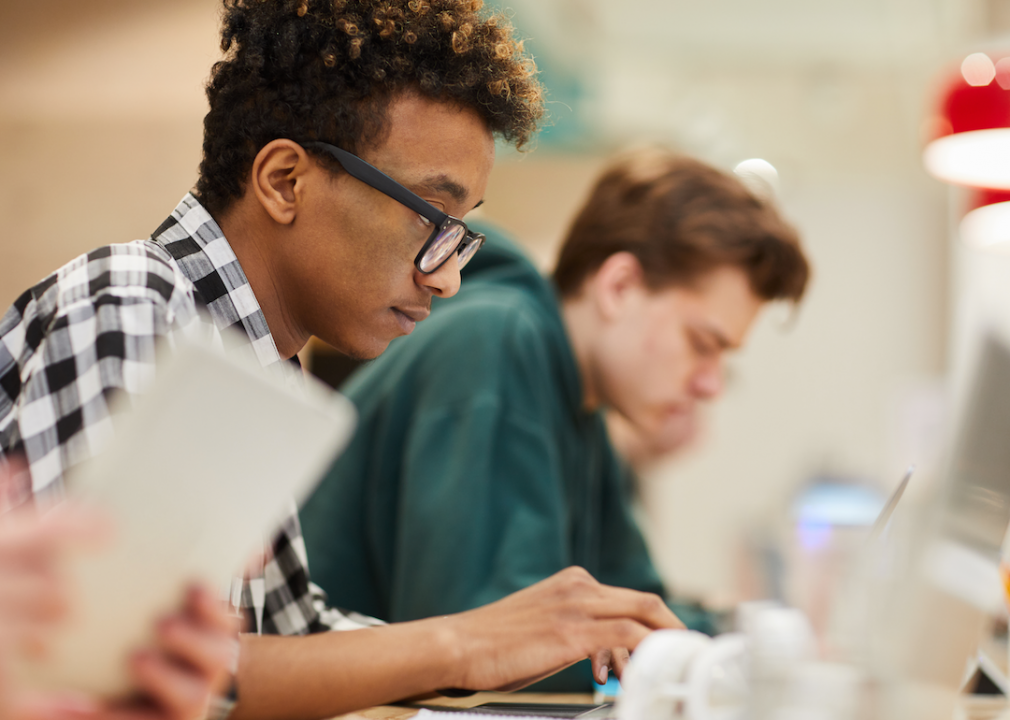 Students working on computers in library.