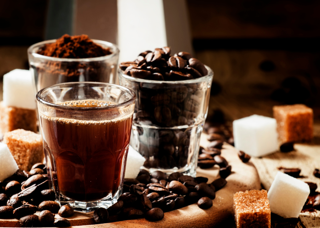 Specialty coffee drinks on wooden tray.