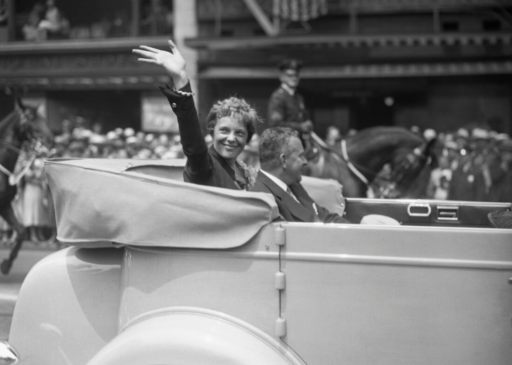 Amelia Earhart waves to parade crowd