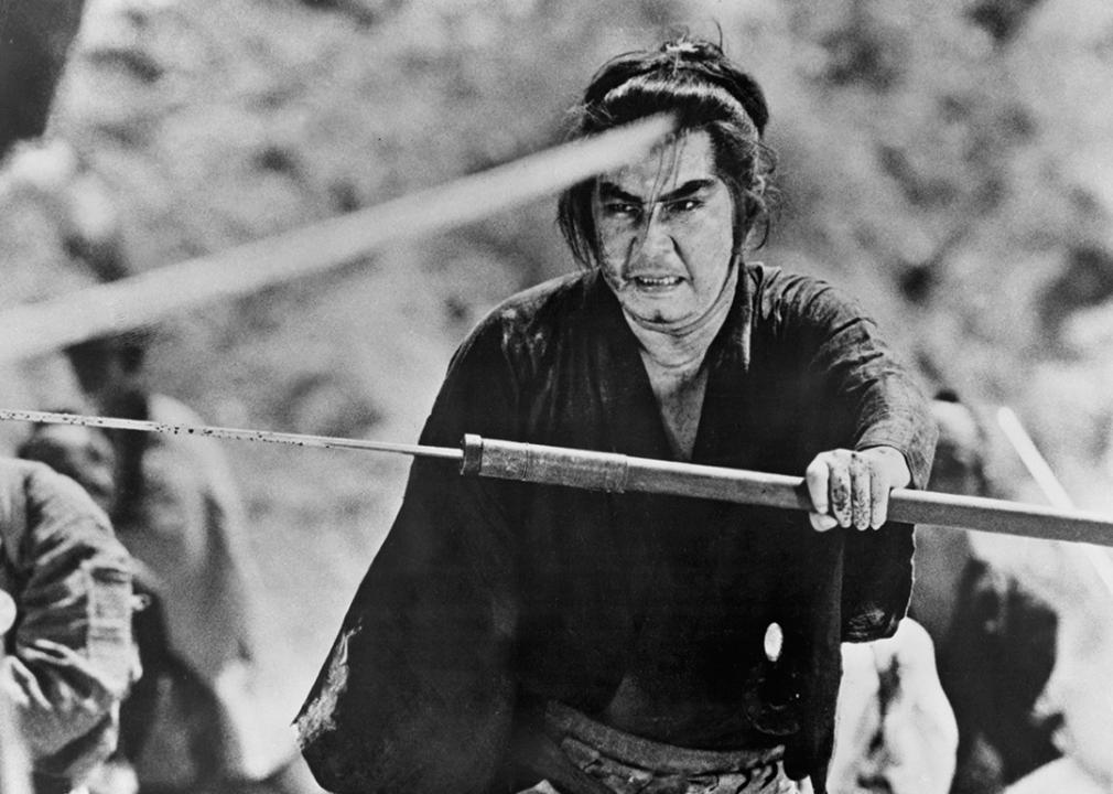 Tomisaburo Wakayama holds up his sword in 