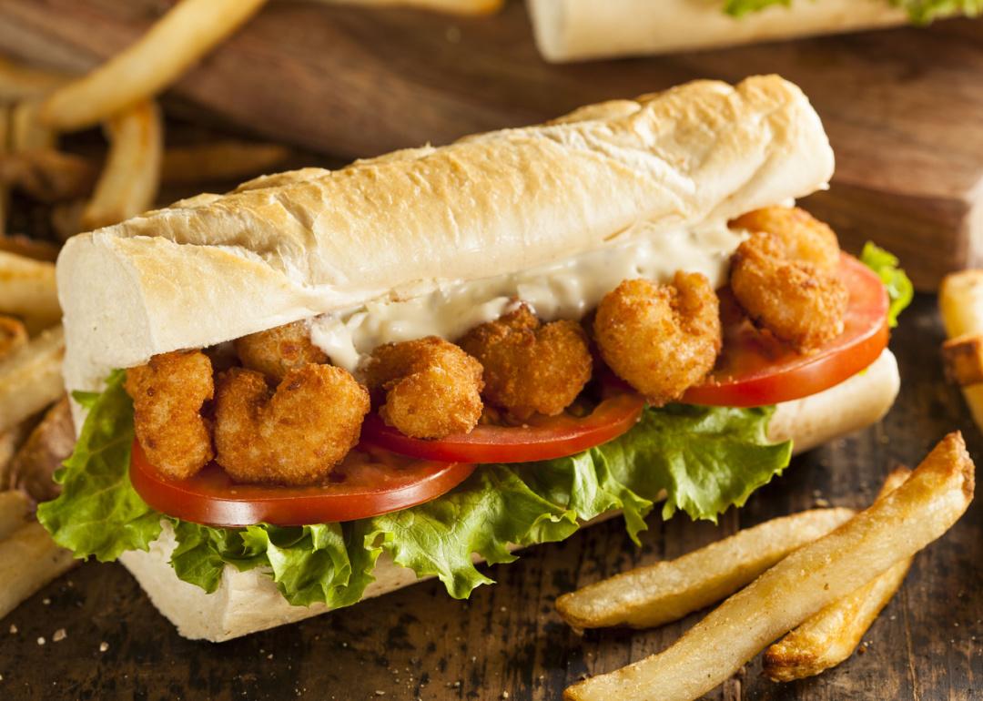 Shrimp po boy sandwich with french fries.
