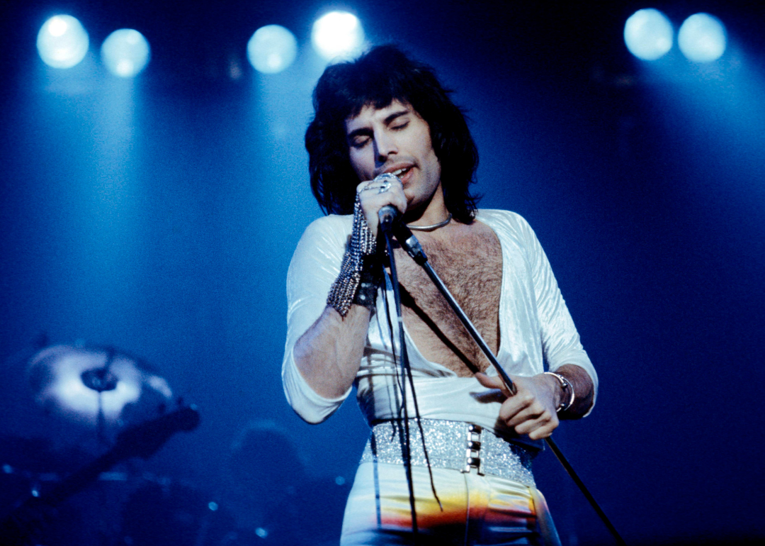 Freddie Mercury and Queen performing live on tage.