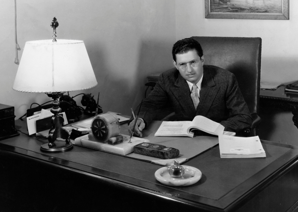 David O. Selznick works at desk.