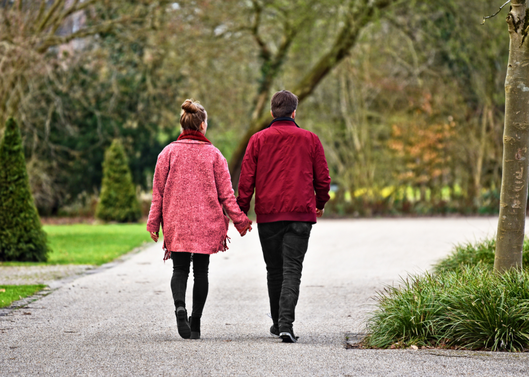 Couple walking in park.