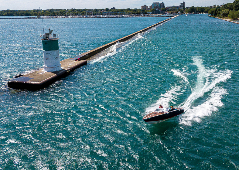 Boat motoring by Waukegan Lighthouse