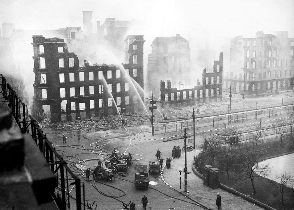 Firemen spray water on the remains of buildings in Manchester.