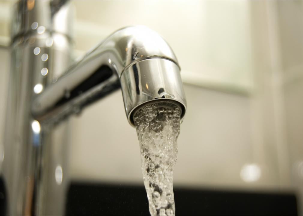 Photo shows a close-up of a faucet with water coming out