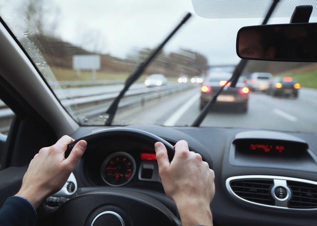 Person driving with wipers on in bad weather.