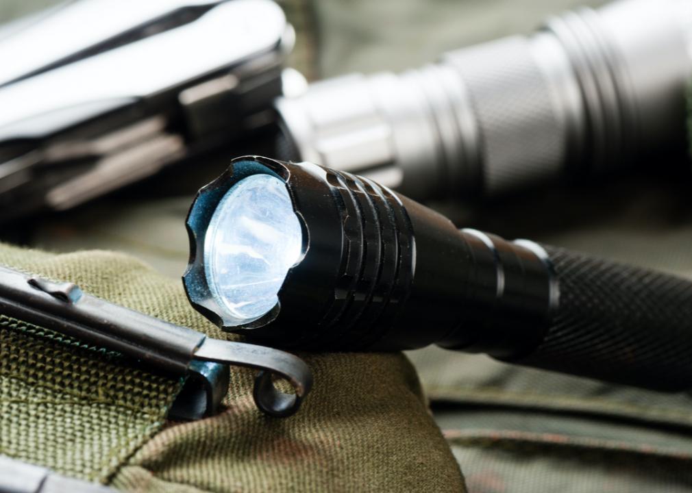 Photo shows flashlights sitting on a bag on a table