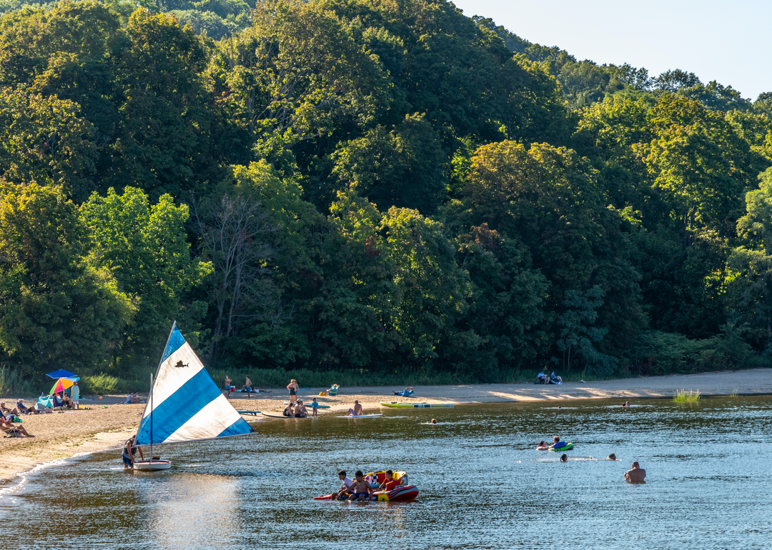 Bathers and boaters in the afternoon sun on Beekman Beach in Oyster Bay.