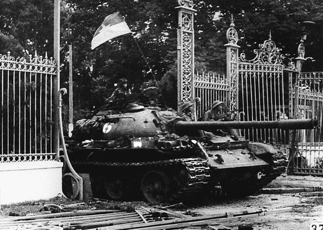 North Vietnamese tank driving through the presidential palace gate in Saigon.