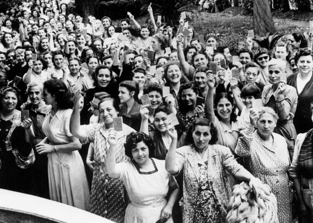 Women of Buenos Aires pose with their identification cards as they go to the polls for the presidential election in 1951