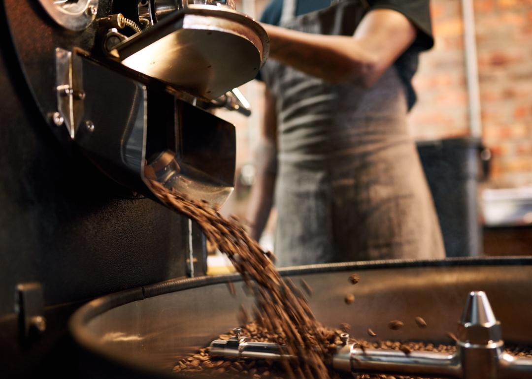 Roaster pouring beans onto cooling tray.