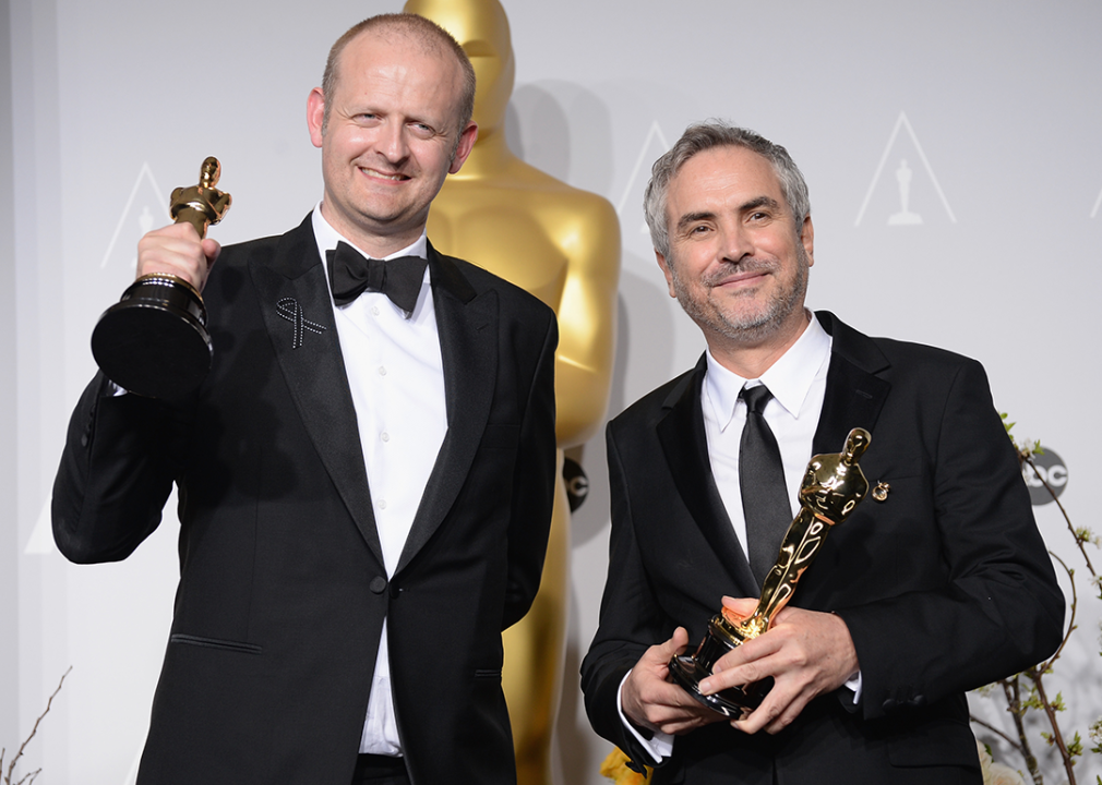 Mark Sanger and Alfonso Cuaron pose in the press room with their Academy Awards.