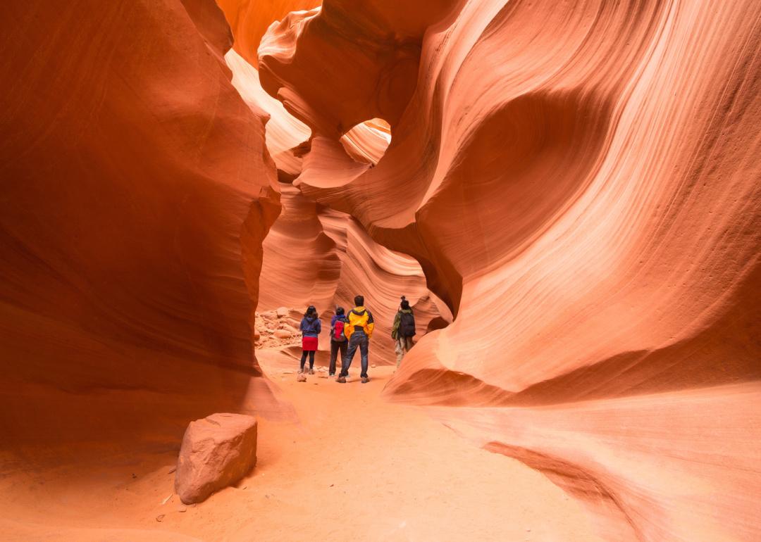 People walking through narrow passageway at Antelope Canyon.