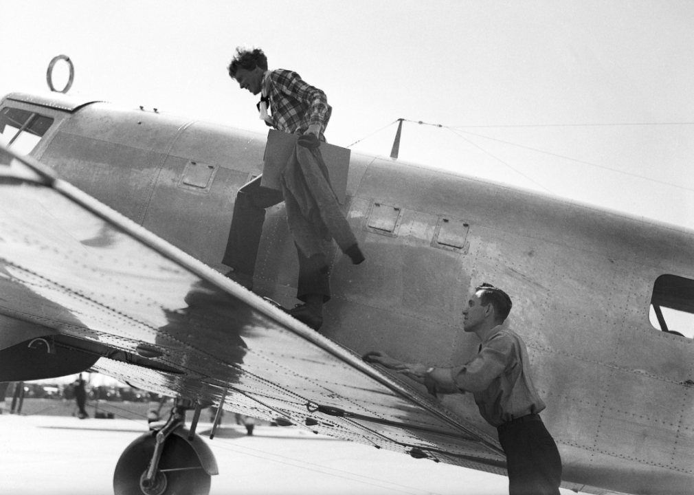 Amelia Earhart making standing on plane before final flight