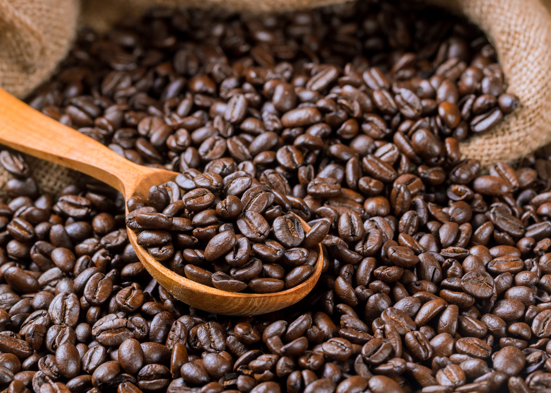 Wooden spoon with fresh roasted coffee.