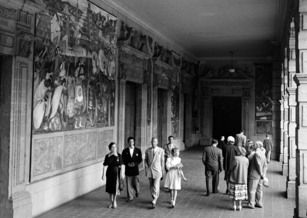 People walk through a corridor in Mexico City, Mexico, circa 1952