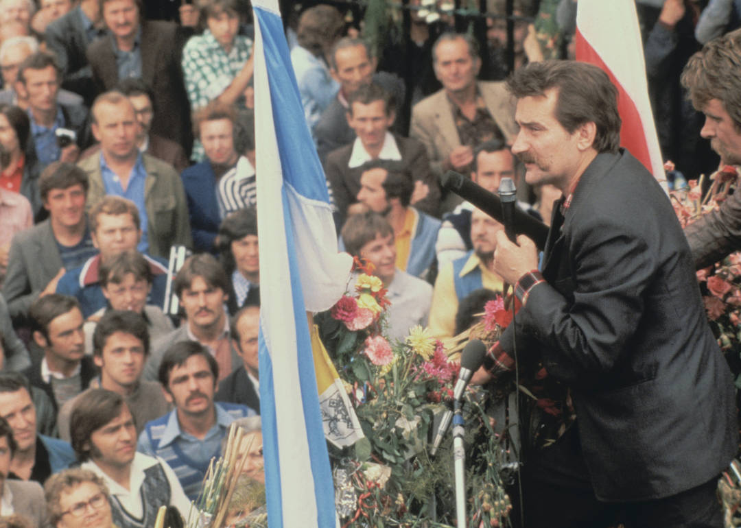 Lech Walesa speaking to his supporters at the Lenin shipyard gate.