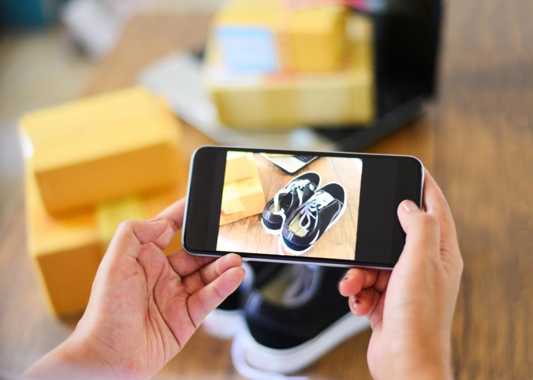 Person photographing shoes to sell online.