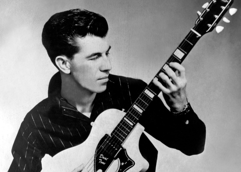 Link Wray plays his guitar as he poses for a portrait.