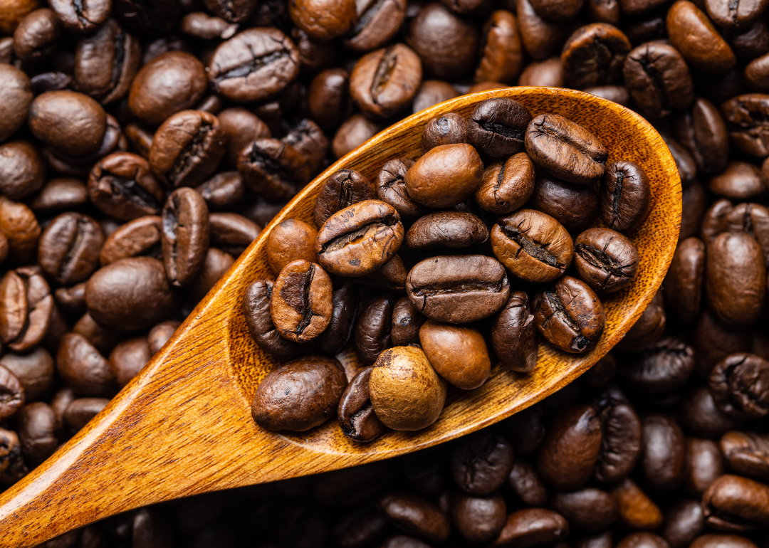 Wooden spoon with fresh roasted coffee.