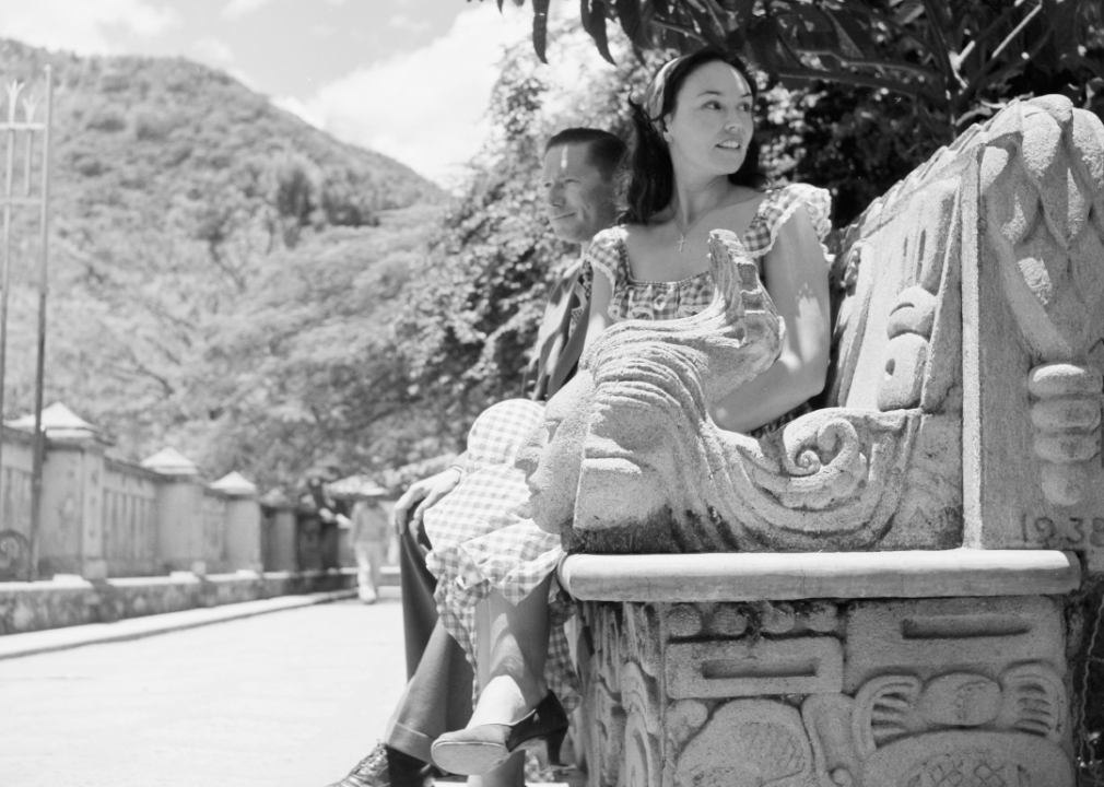 A woman sits on a bench in Tegucigalpa in 1952