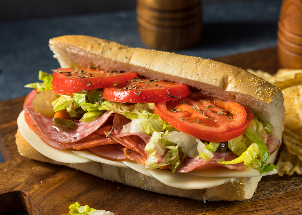 Cold cut sub sandwich with lettuce and tomato.