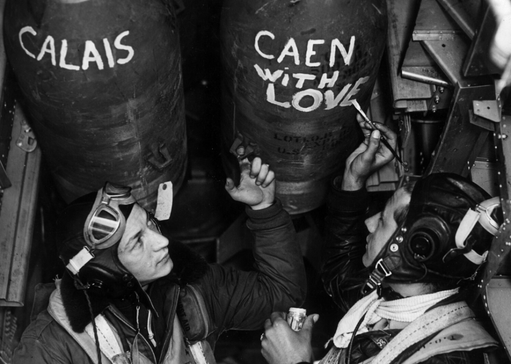 Airmen of the U.S. 8th AAF paint their bombs before setting off for a raid over Caen and Calais, France, on June 12, 1944.