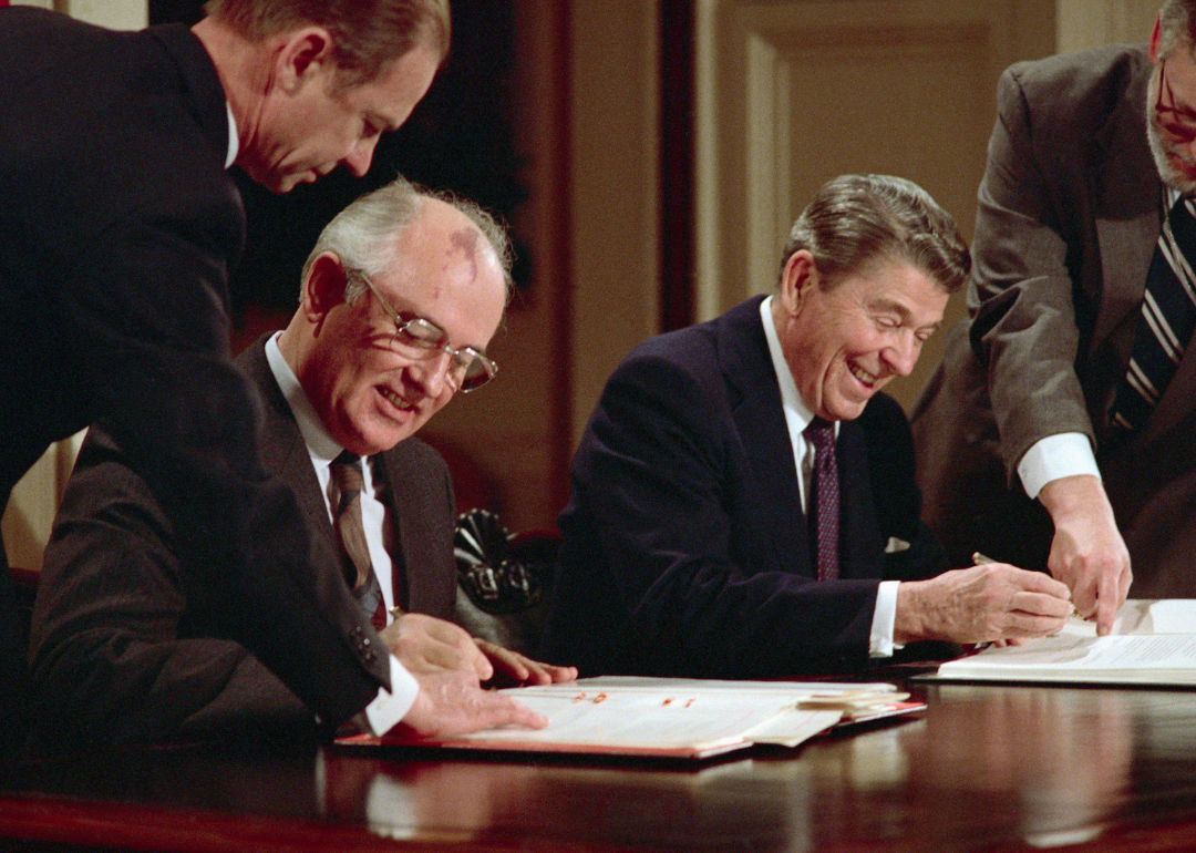 Ronald Reagan and Mikhail Gorbachev signing arms control agreement.