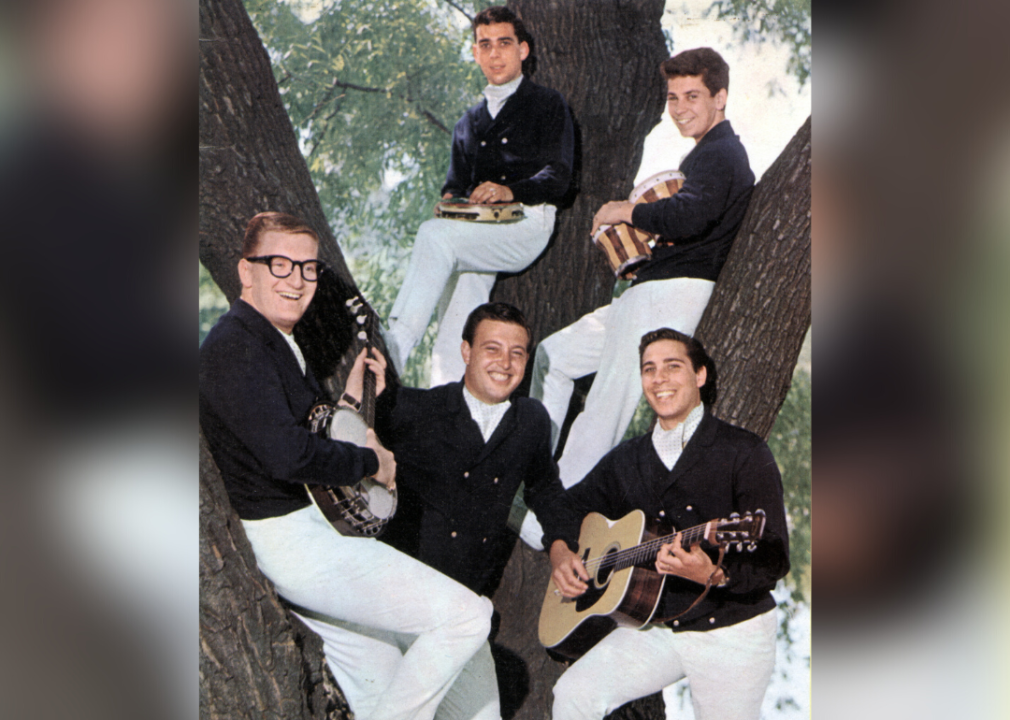 The Tokens pose in a tree for a promotional portrait.