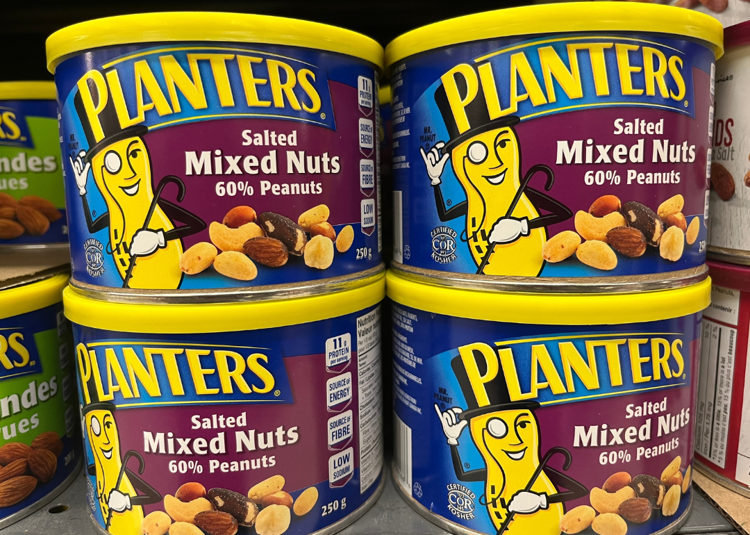 Cans of Planters salted mixed nuts in supermarket.