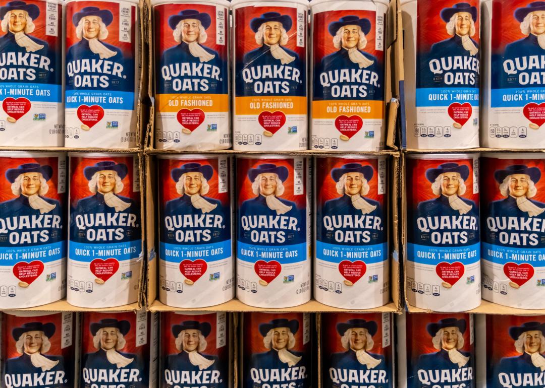 Grocery store shelves with canisters of Quaker Oats.