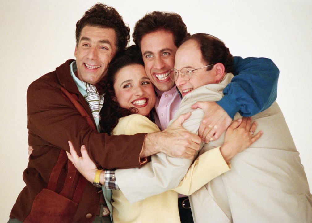 The cast in a group hug in a promotional still for ‘Seinfeld.’  