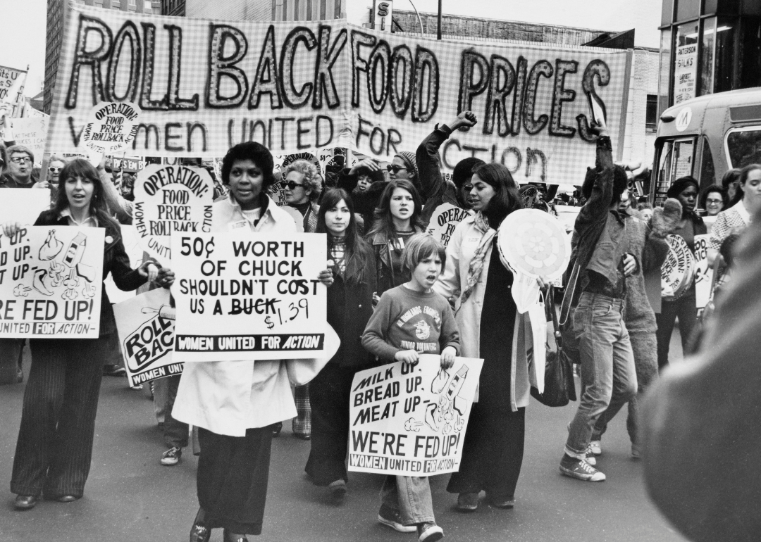 Women and children marching to protest the rise of food prices.